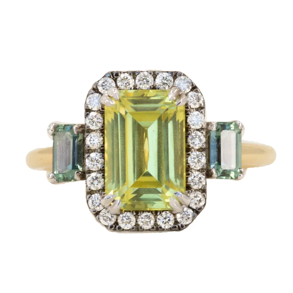 2.62ct Emerald Cut Nigerian Sapphire and Montana Sapphire Low Profile Scallop Cut Three Stone Ring with Antiqued Diamond Halo in 18k Yellow Gold