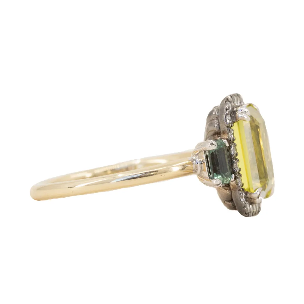 2.62ct Emerald Cut Nigerian Sapphire and Montana Sapphire Low Profile Scallop Cut Three Stone Ring with Antiqued Diamond Halo in 18k Yellow Gold